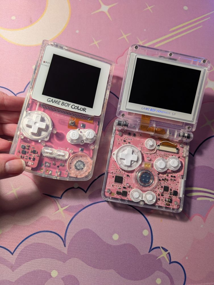 A gameboy colour and game boy advance sp with pink pcb