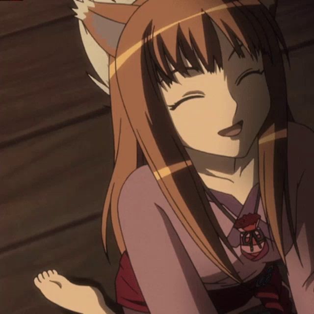 a girl with a fox tail is smiling and wearing a pink shirt