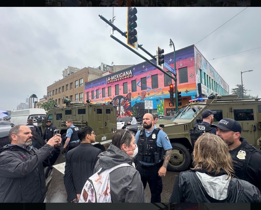 MPD officers, community members, and military style vehicles.
