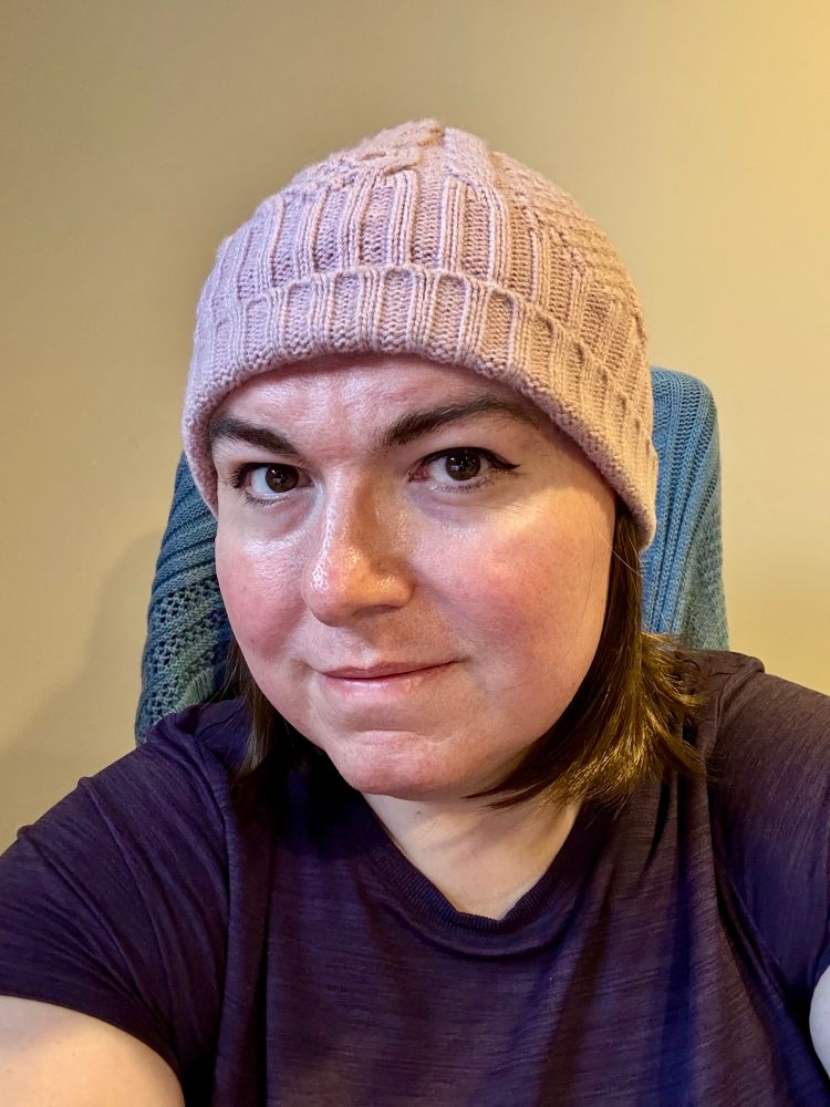 it's Nora, but she doesn't have glasses on! her hair is shorter and lighter in colour, and she's wearing a pink toque (or as the southerners call it a *shudder* beanie). the little halo wig looks pretty good, and she's hoping this will be way more comfortable for outdoor winter fun