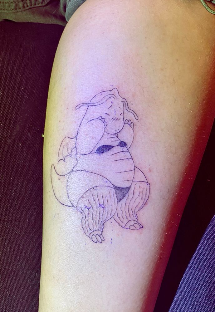 tattoo of a curvy dragonite in a bra, panties and leg warmers looking quite bashful and possibly drunk