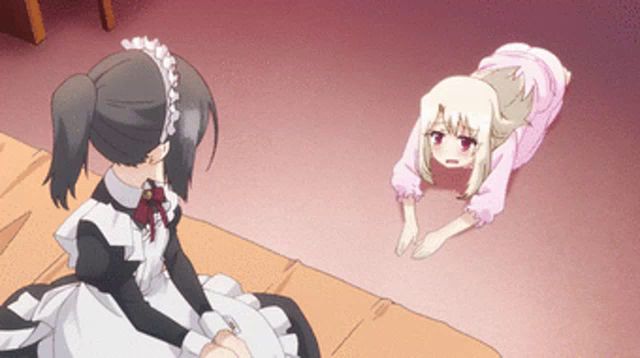 a girl in a maid outfit is sitting on a bed next to another girl