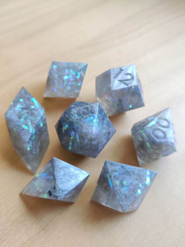 the full set of dice arranged neatly on a wooden table