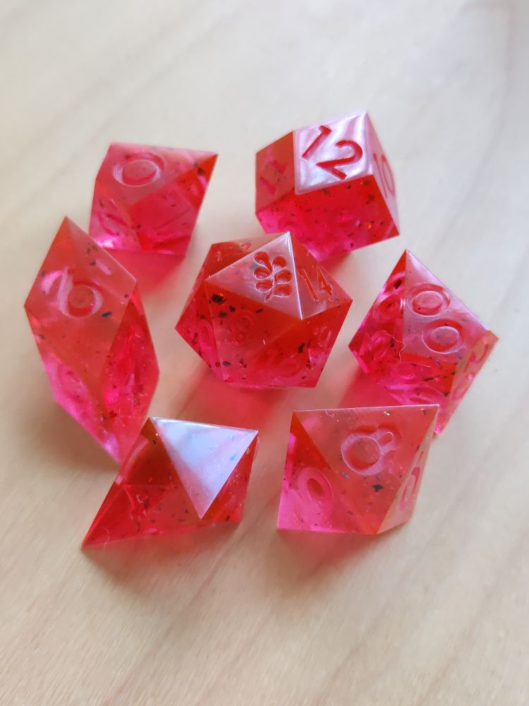 the full set of dice arranged neatly on a table