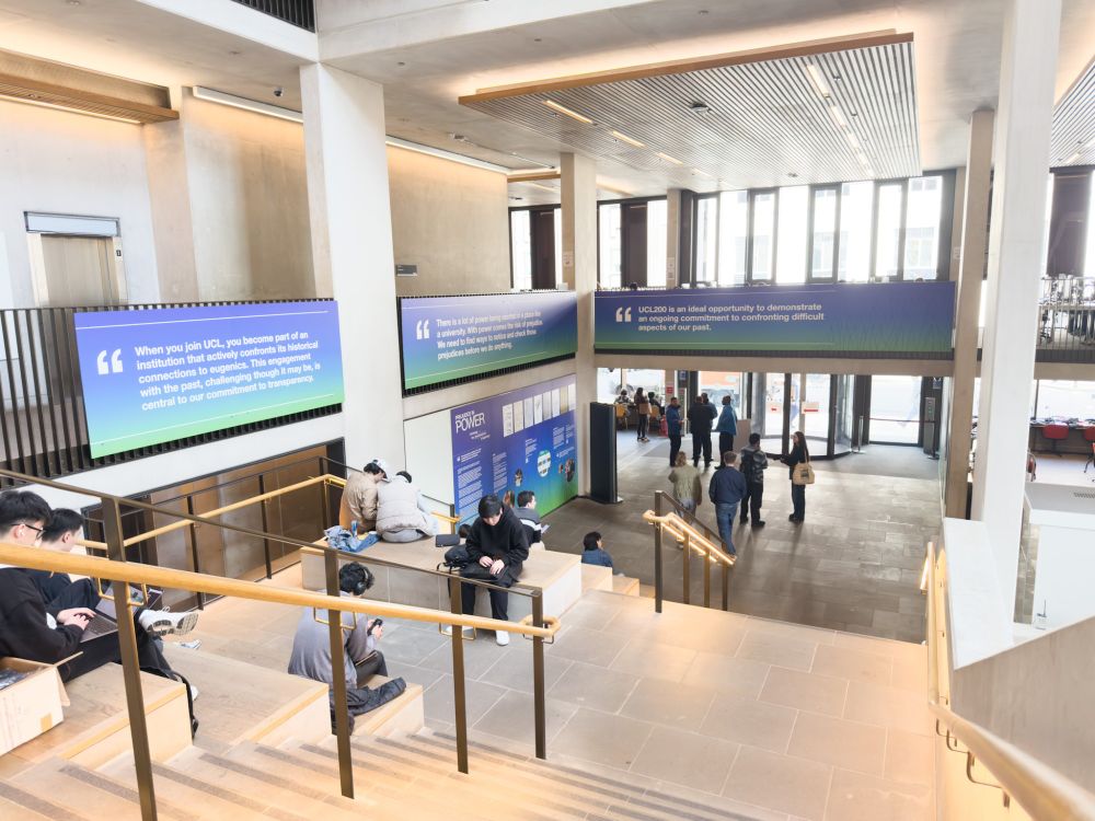 Students sat at the Student Centre next to the Prejudice in Power installation. 