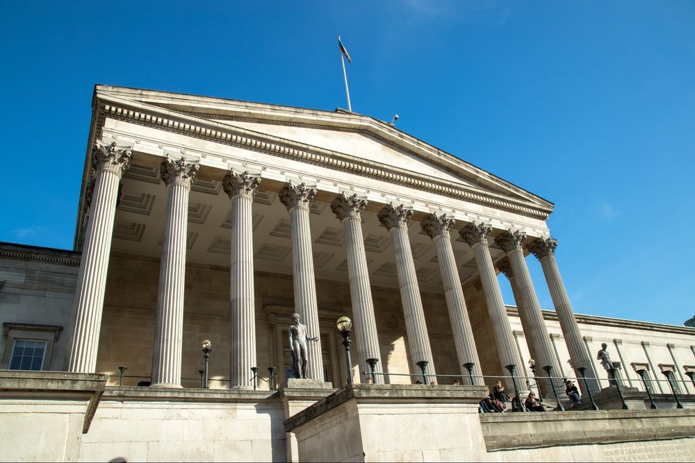 UCL's portico building surrounded by clear blue skies.