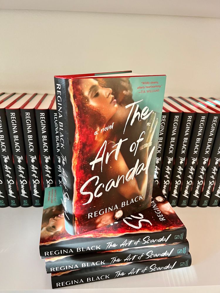 A photo of a stack of The Art of Scandal hardcover books.