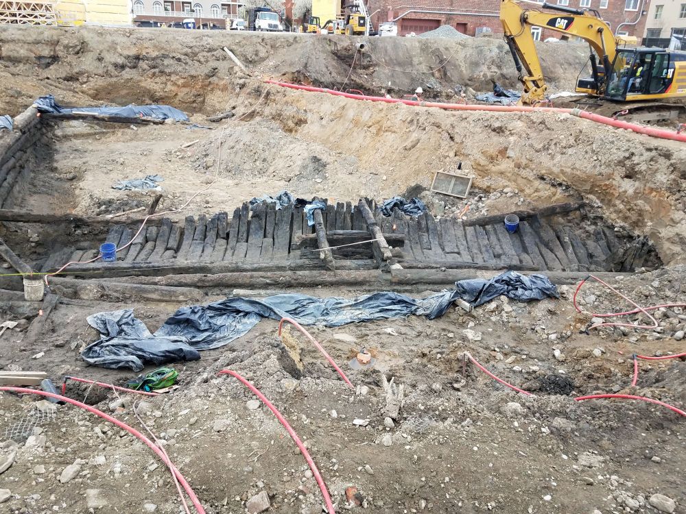 Bottom port frames, keelson , and keel of a late 18th century wooden ship, buried in the ground. Starboard not present. 