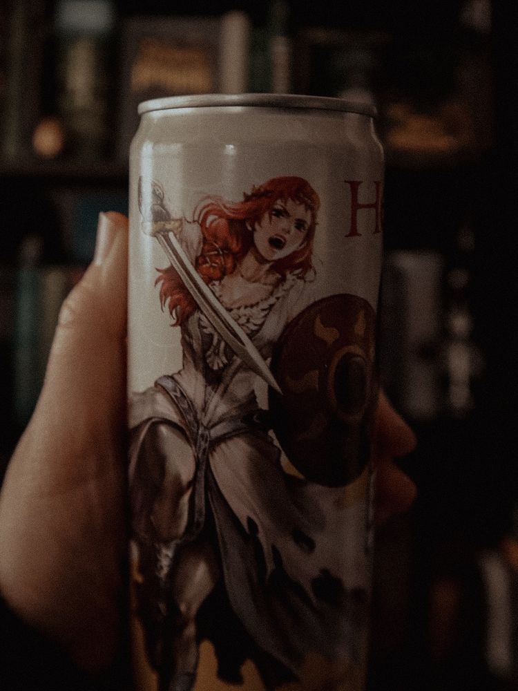 Canned tea featuring Hera, from the upcoming War of the Rohirrim film, holding sword and shield.