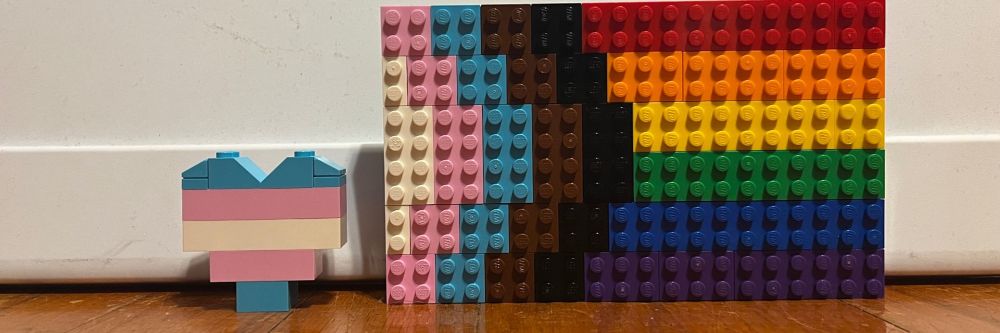 Pictured: a Lego Trans heart next to a Lego Pride flag
