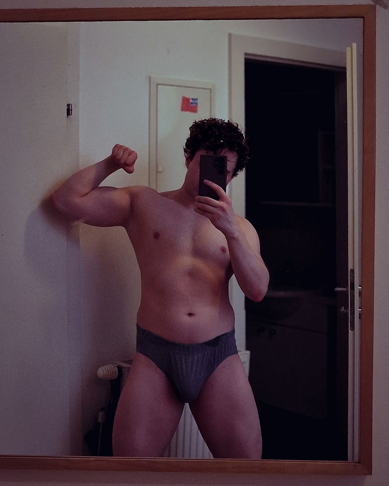 mirrorselfie in grey underwear while flexing biceps  