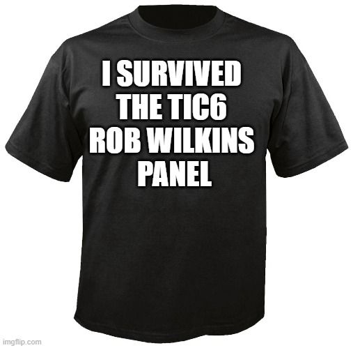 Black T-shirt with bold text: I survived the TIC6 Rob Wilkins Panel