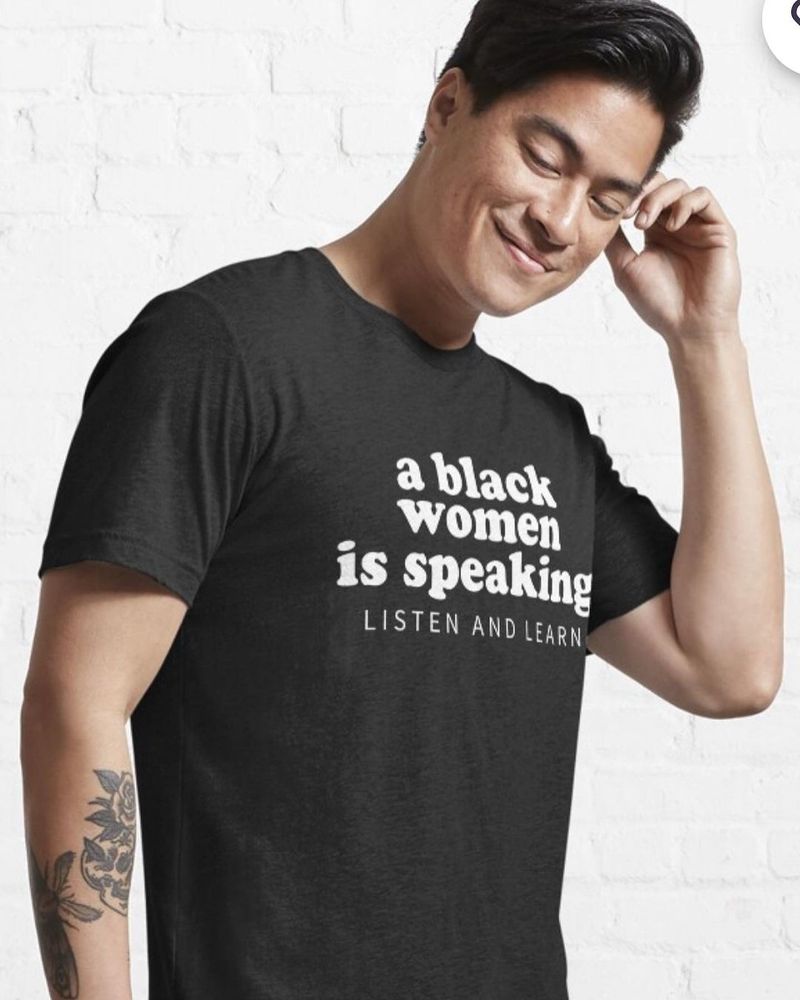Image of a t-shirt model who is not Black wearing a t-shirt which reads as follows: "a black women is speaking listen and learn"