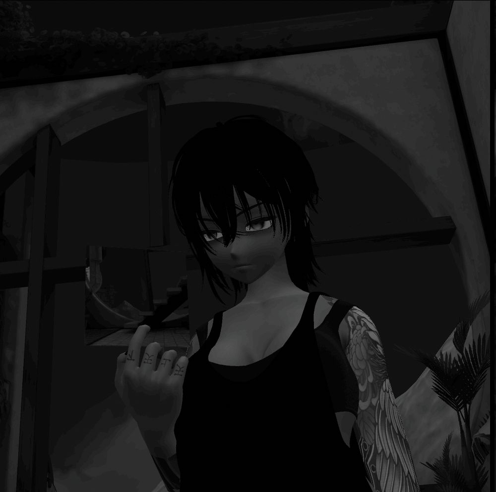 black and white photo of Ayachii holding another black and white photo thought provokingly 