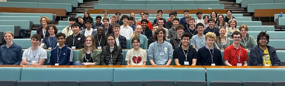 Photo of smiling students in a lecture theatre