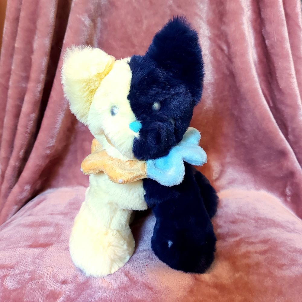 Plush cat that is half yellow, half dark blue with stars