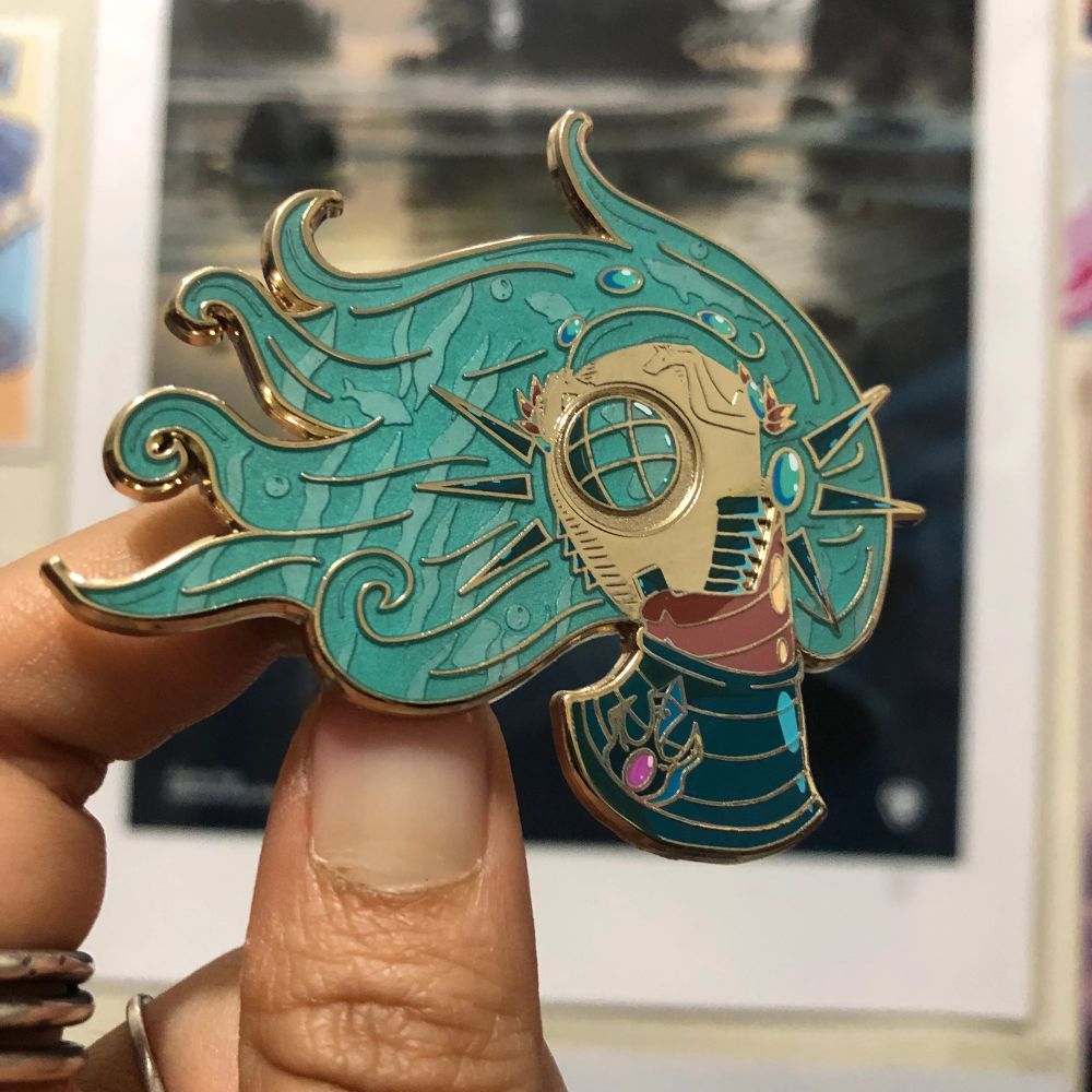 A photo of my Hades-inspired robot Poseidon pin with an old diving helmet inspired face