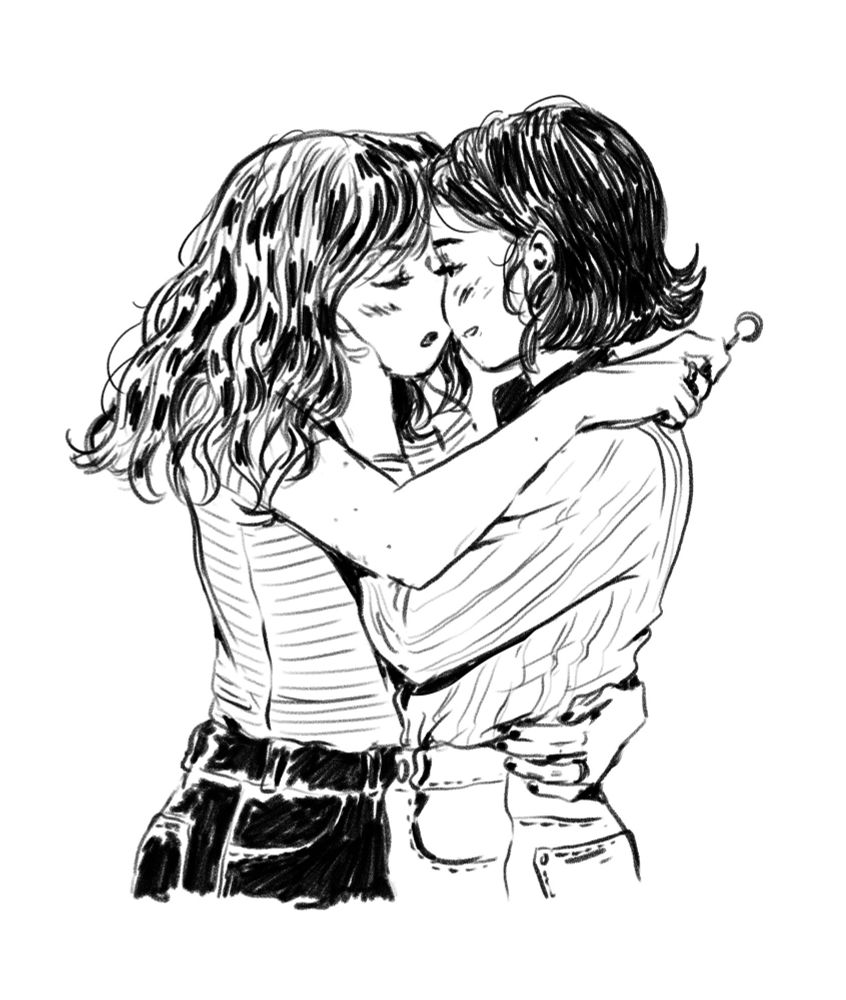Lesbian couple about to kiss, one holding the other's face, while the other has a hand on her lower back and a lollypop on her right hand