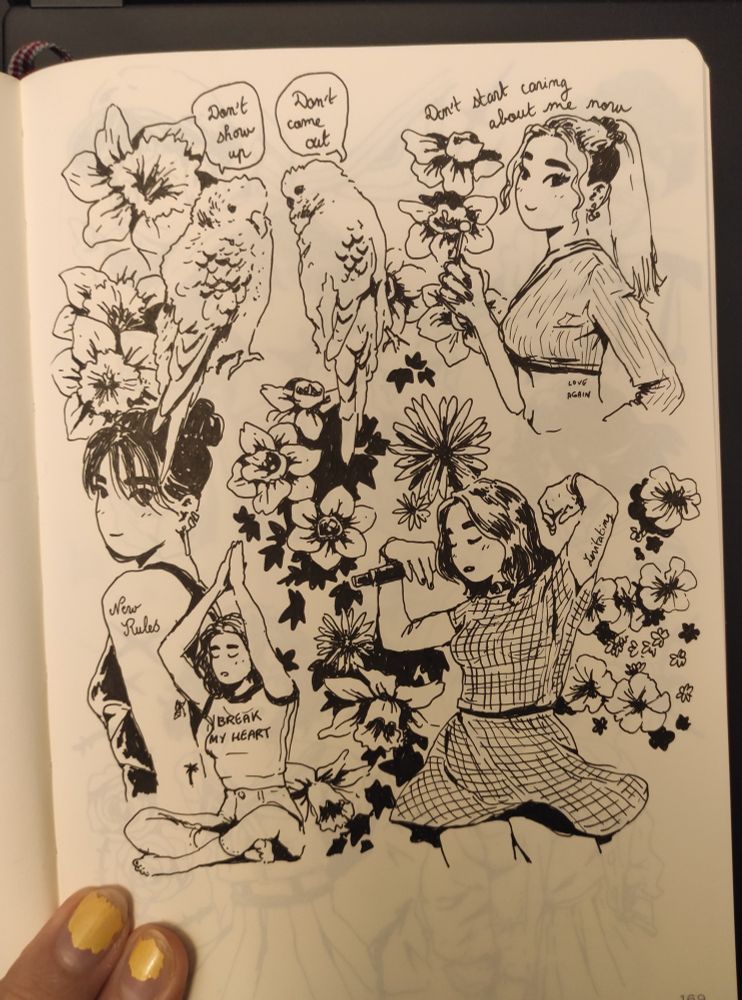 Pic of a sketchbook page with ink drawings on it: basically a Dua Lipa fan page, various drawings of her, dancing, doing yoga, with flowers, two parrots and lyrics from her songs