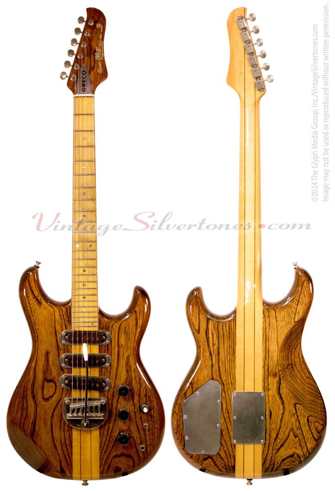 This is a double cutaway, solid body, Greco Go II, made in Japan, circa 1978. It features a natural finish, a neck-through design, three single coil pickups with metal surrounds, two metal strap pins, three black, plastic numbered knobs, and an adjustable, metal bridge/floating tailpiece with six individually adjustable, metal roller-style saddles. This Go II comes with an original brown leather soft carry case. The guitar is in great shape especially for an instrument that is over 37 years old. It looks terrific, plays fantastic and sounds as good. This nearly mint condition guitar is perfect for players and collectors. Description from VintageSilvertones.com
