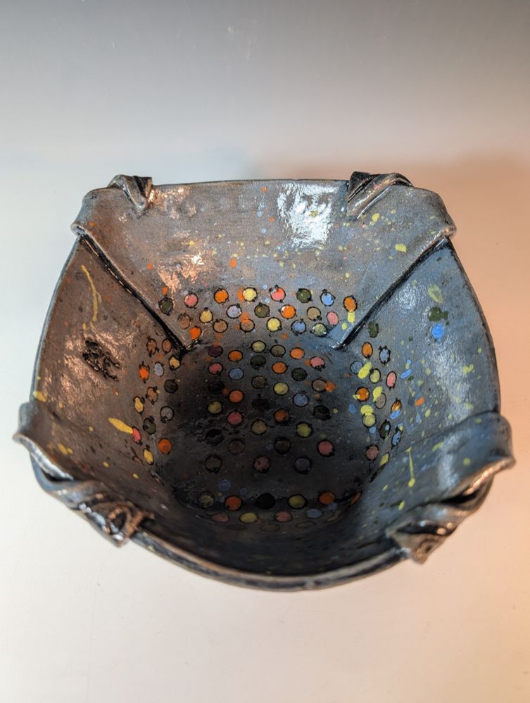 Clay folded bowl- theme : Future. This is an loosely decorated  abstract design on a bowl with many bright colors that has been folded from a slab to turn into a bowl. This is a top down view. 