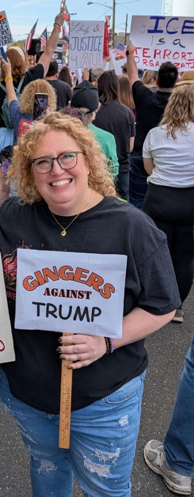 A picture of me (a redheaded woman) with a sign that says "Gingers against Trump" at a No Kings protest. 