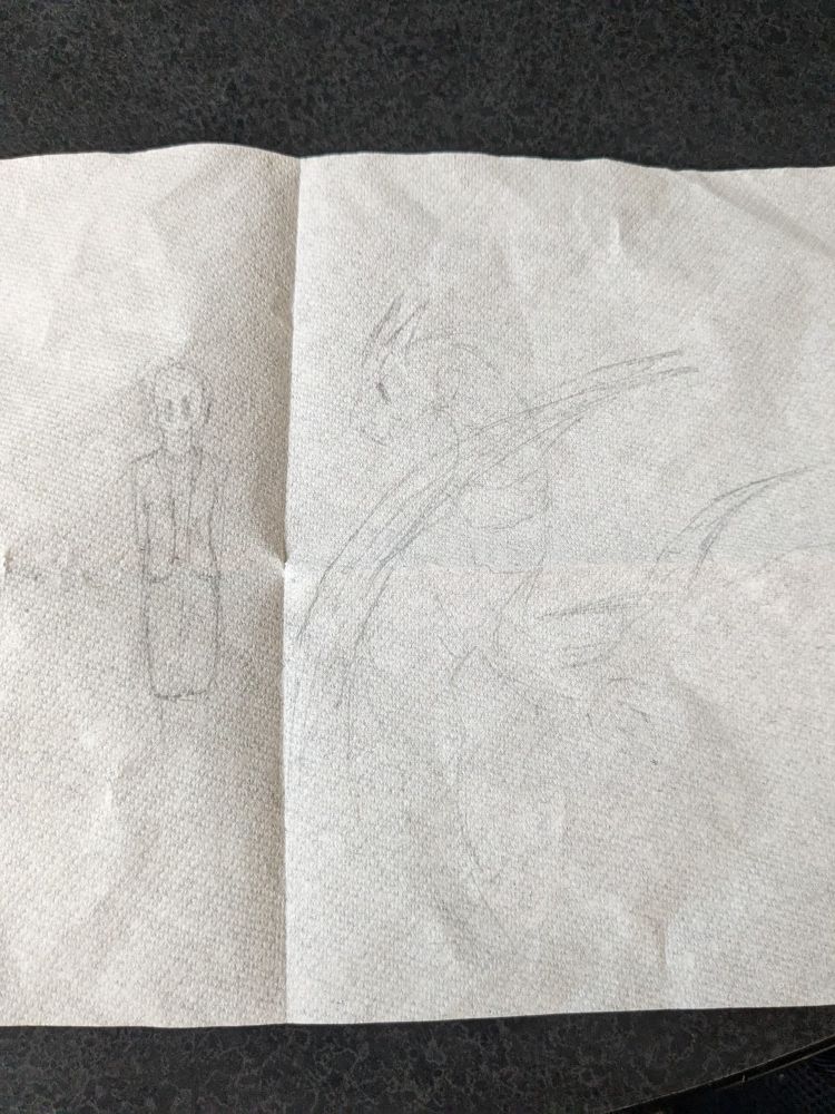 Faint pencil doodles on a paper towel of a woman and a dragon
