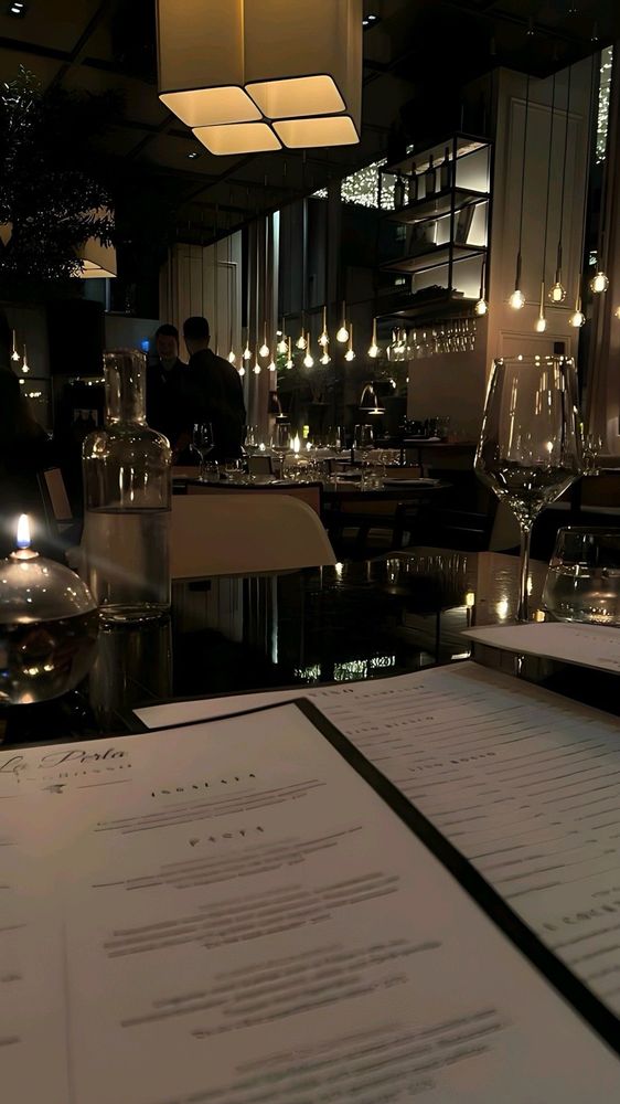 a table set for two inside a dimly-lit restaurant 