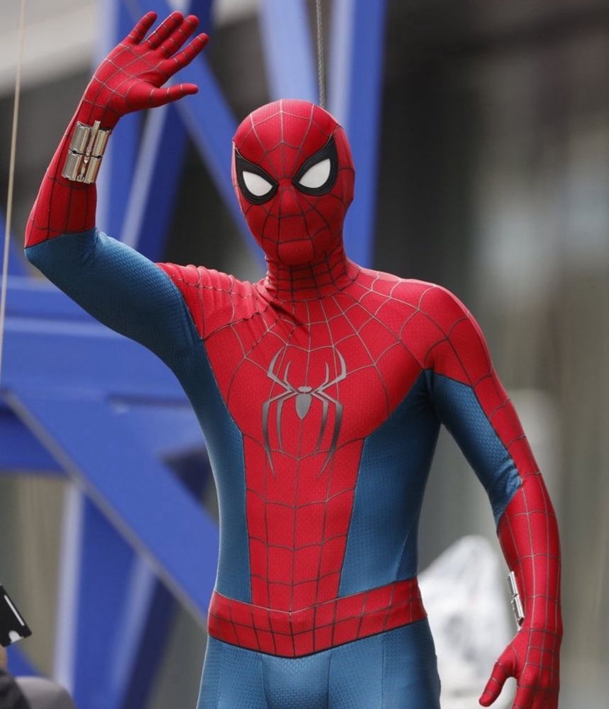 Tom Holland in his Spider-Man: Brand New Day suit. It's the most gorgeous Spider-Man suir in existence. Vibrant, saturated red and blue with a gorgeous, gorgeous big spider on the chest with bulky homemade web shooters. Its so perfect. 