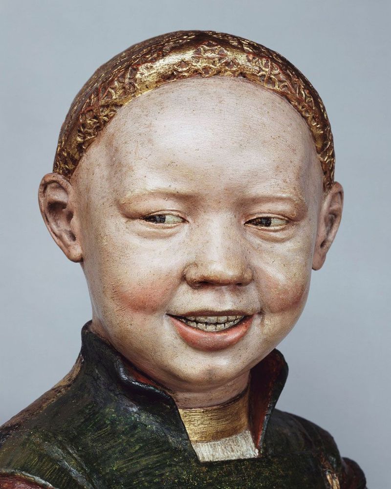 A terracotta statue of Henry VIII as a child, with the creepiest grin you ever saw.