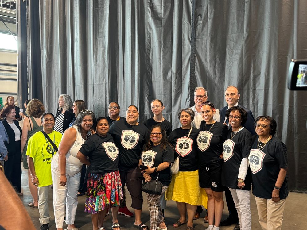 Members of the Africville community wearing Africville Seasides shirts and posing for a photo
