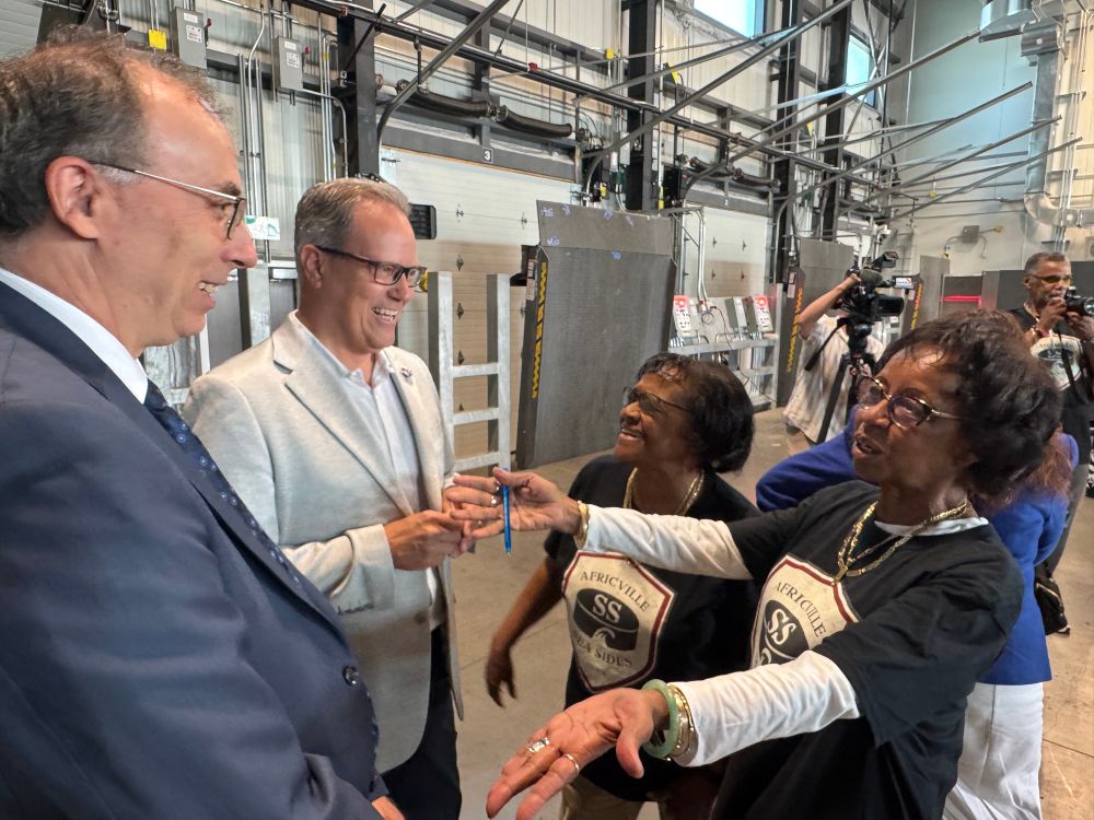 MP Fisher with members of the Africville Community at the Port of Halifax. People are smiling
