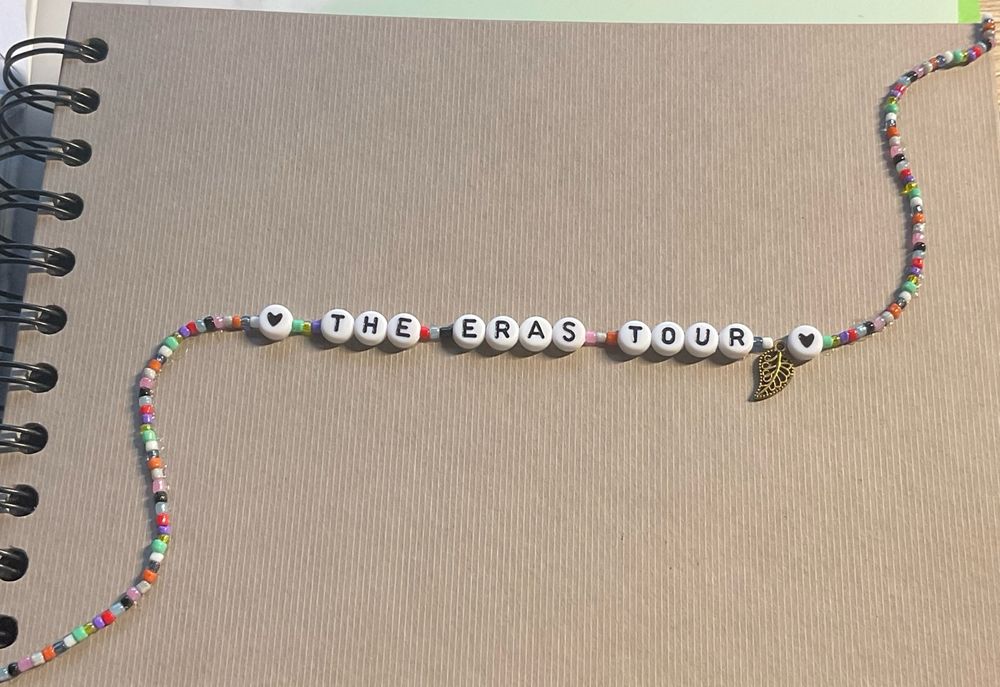 Cover of a notebook, beads glued on “the eras tour“ 