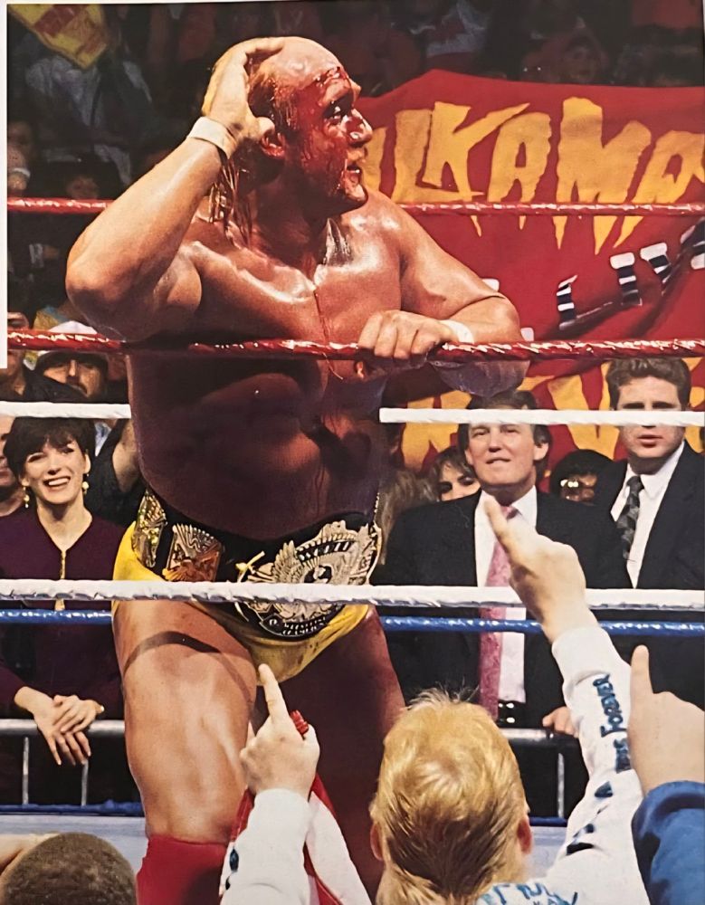 Ghislaine Maxwell and Donald Trump sitting with each other at Wrestlemania 7 as Hulk Hogan poses in the ring.