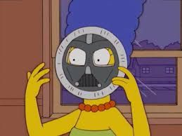 Marge with a paper plate over her face, drawn to resemble Darth Vader