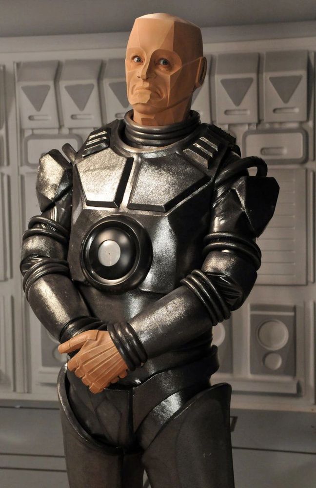 Kryten from Red Dwarf, a grey-ish mechanoid with an slightly odd shaped head.