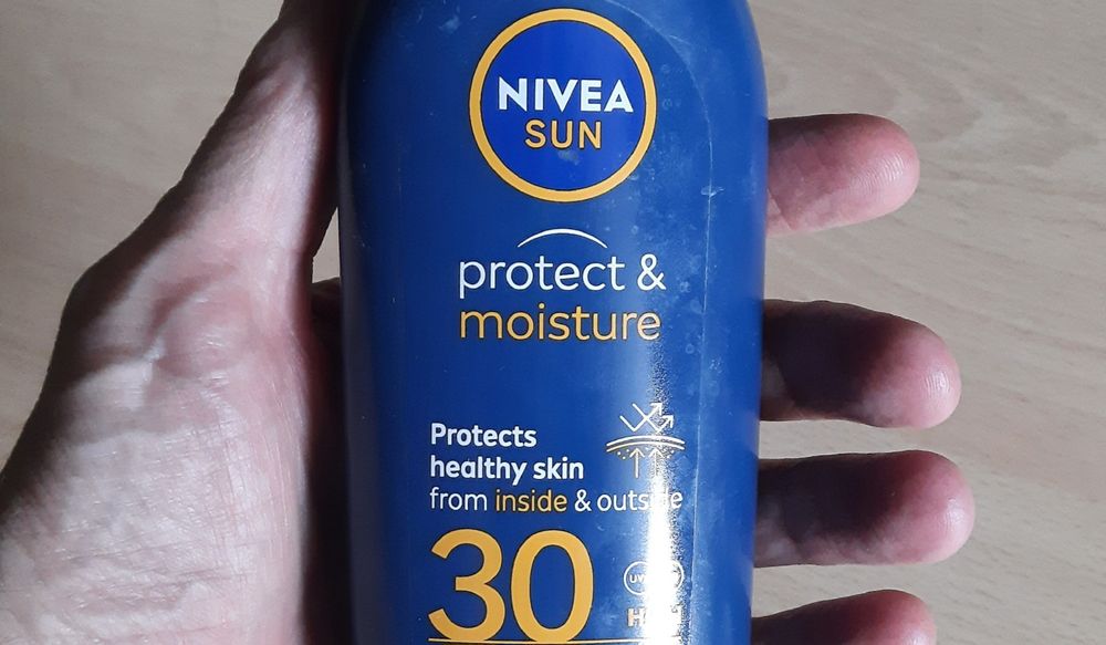A bottle of Nivea sun cream, bearing the slogan 