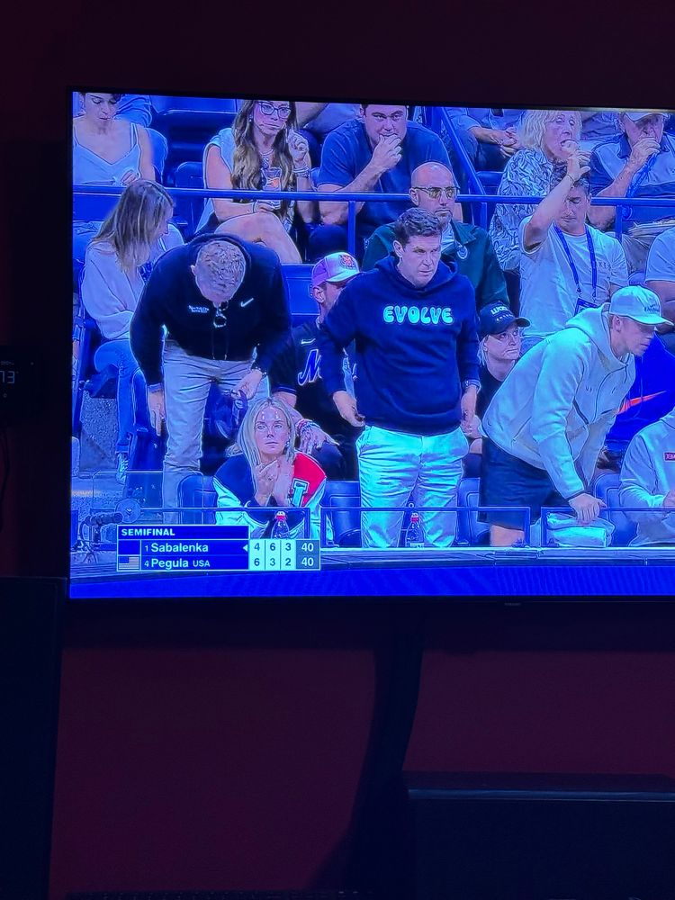 A man wearing a sweatshirt with the word evolve on it.