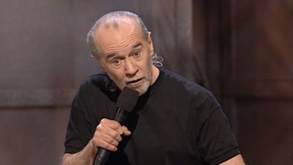 A screenshot of George Carlin performing stand-up comedy.