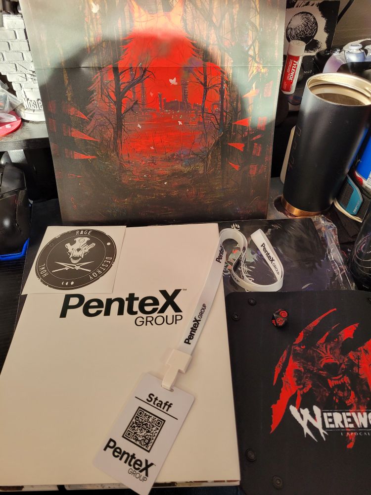 Picture of the deluxe edition Werewolf: The Apocalypse 5th edition Core Rulebook from the French language printing by Arkane Asylum. The book is all white with "Pentex Group" in black lettering on the front. 

Also pictured are additional items including a Pentex Group Staff badge and lanyard, a black and red die with WtA symbols on it, a WtA themed dice tray depicting  the logo and a red and black image of a Werewolf, and a poster with the art from the normal cover of the 5th edition core Rulebook. 