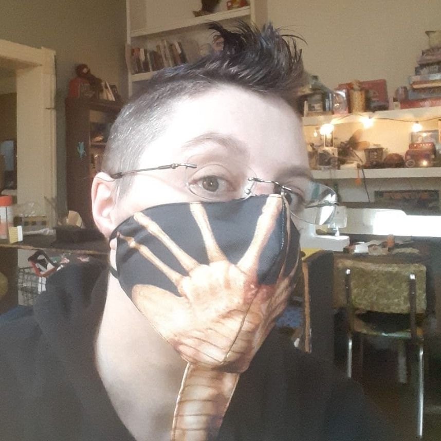 Selfie of me wearing a facehugger mask.