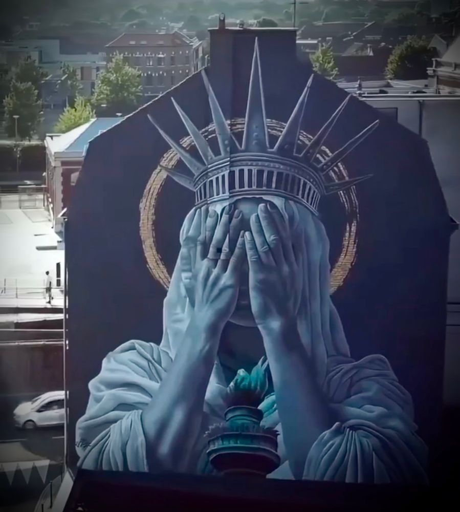 Mural painted by Judith de Leeuw in Roubaix, France depicts the Statue of Liberty covering her face in shame.