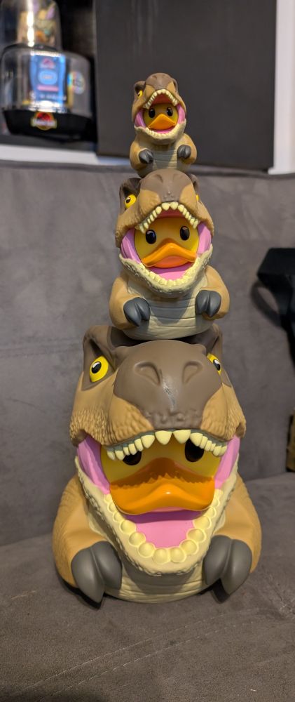 A teetering tower of T-Rex Tubbz, mini, regular and XL