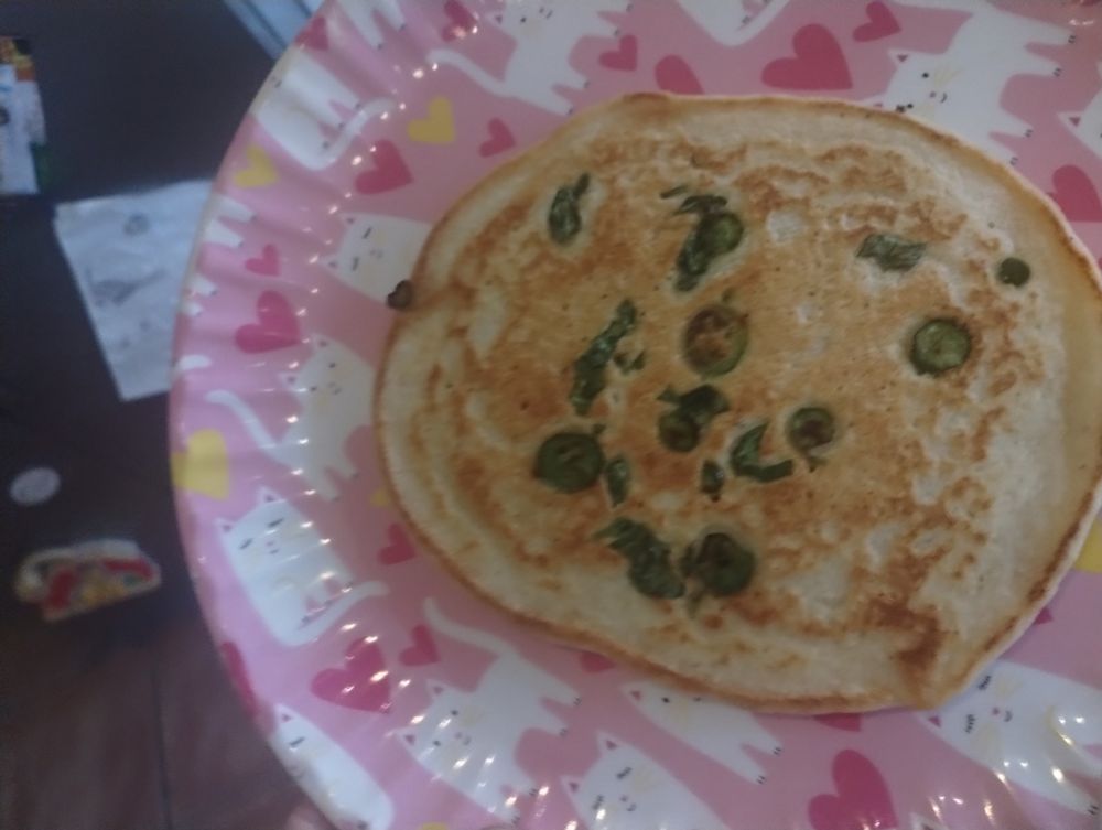 An almost normal looking pancake, but there's green bits? Tbh, I don't remember what they are, probably chilis
