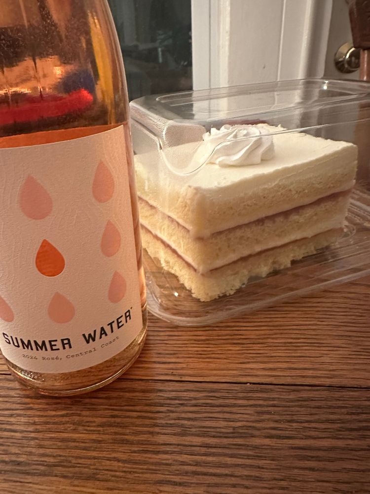 rose and cake on a brown wooden table