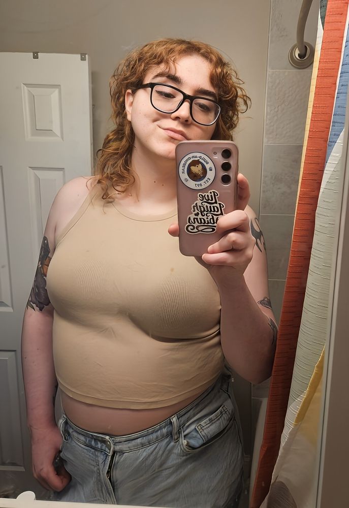 A selfie of me in a crop top and jeans
