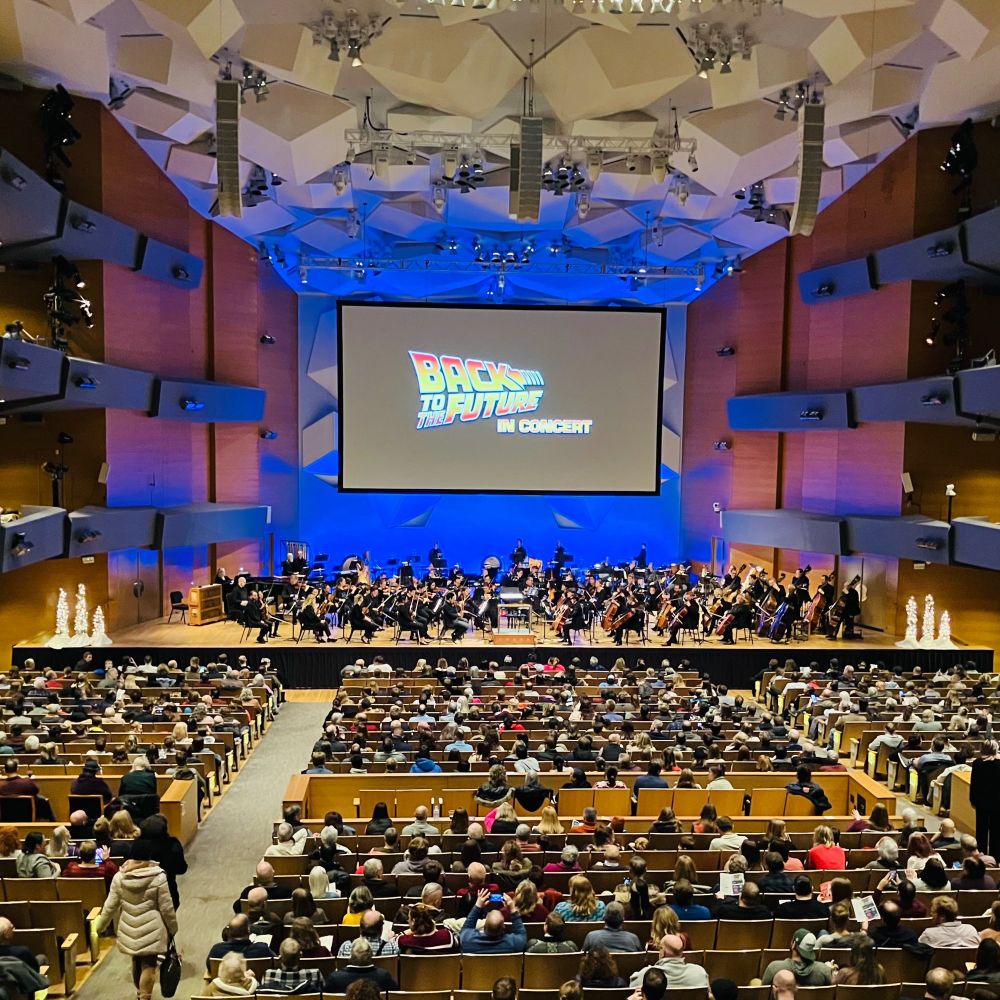Minnesota Orchestra musicians and audience members viewed from the back balcony at Orchestra Hall.