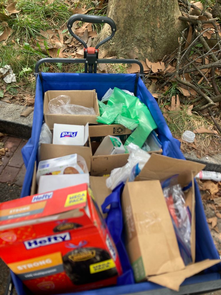 top view of a blue cart with supplies including cookies, rolling papers, trash bags, fruit cups, and more!