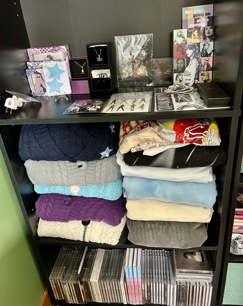 Zoomed in on shelves, CDs, cardigans and other clothing, and jewelry, etc. 