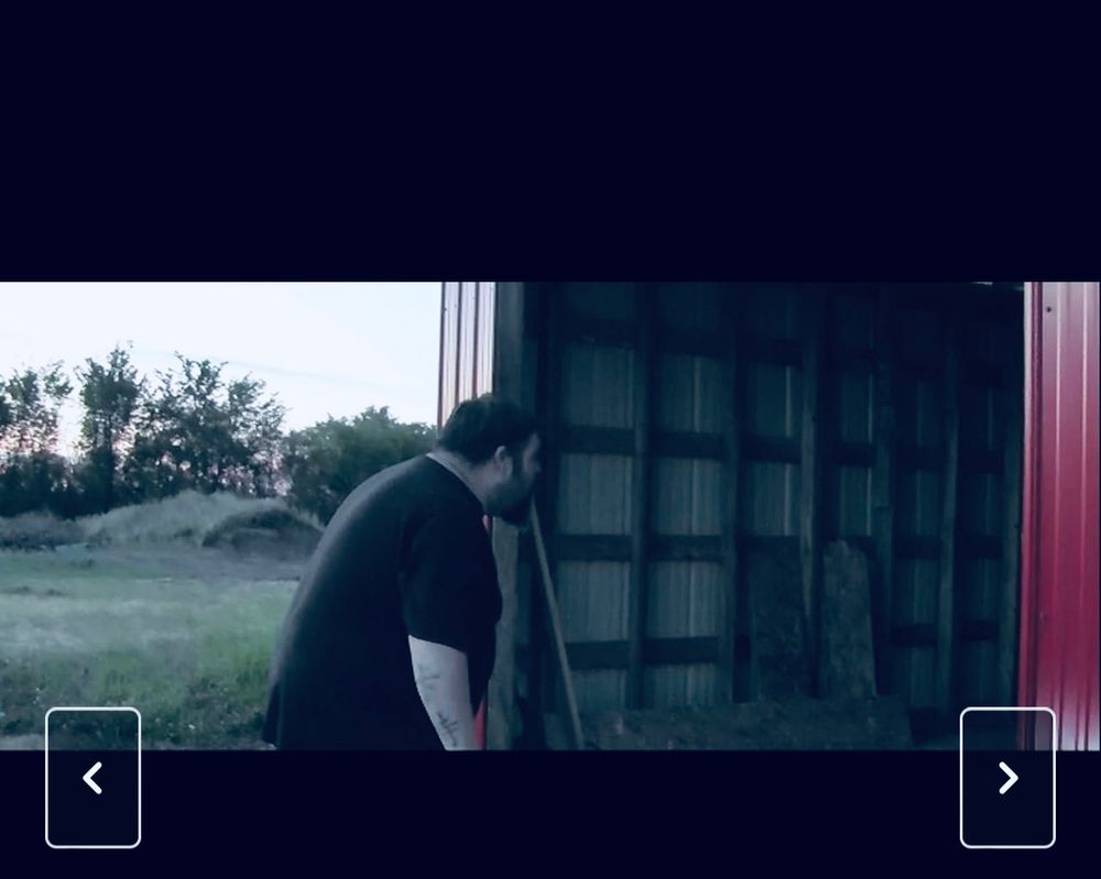 A dad peers into a red shed on a farm at dusk. Scene from “GOREphers” a nonprofit film whose proceeds goes to the Swift Current, Saskatchewan animal shelter, the SPCA. Available on DVD from https://payhip.com/DeadPrairiesProductions